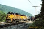 Chessie, B&O GP40-2 4301-C&O GP38 3870-L&N U23B 3298, with eastbound R396. about to head up the Yough gorge and the east slope of Sand Patch grade, at S. Connellsville, Pennsylvania. July 1, 1987. 